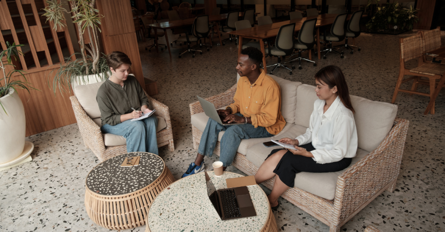 Networking discussion in a modern workspace where professionals build referrals, connect with hiring managers, and strengthen a long-term job search strategy.
