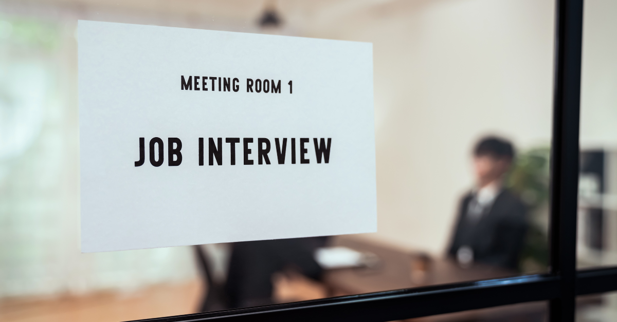 How to prepare for a job interview, meeting room door with “Job Interview” sign.